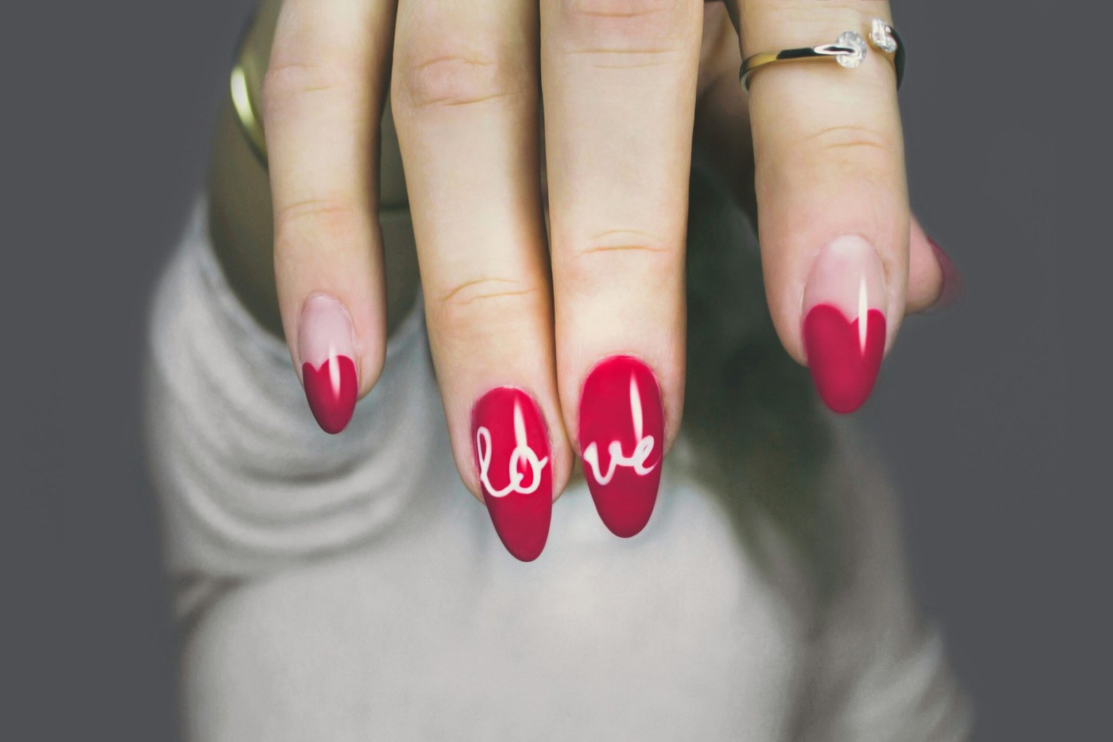 selective focus photography of woman's pink manicure